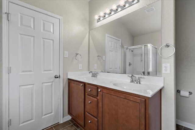 121 Brazoria Trl, San Marcos, TX 78666 - bathroom with a stall shower, double vanity, and tile patterned floors