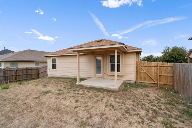 121 Brazoria Trl, San Marcos, TX 78666 - back of house with a patio, a fenced backyard, and a gate
