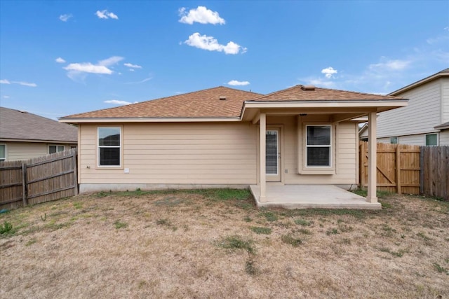 121 Brazoria Trl, San Marcos, TX 78666 - back of house with a patio, a fenced backyard, and a shingled roof