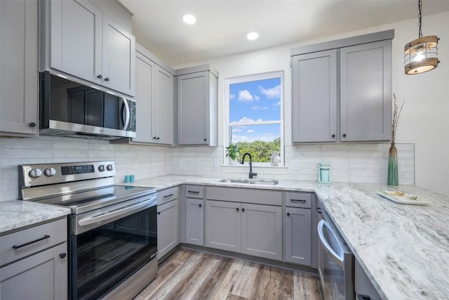 1156 Timberlane Dr, Canyon Lake, TX 78133 - kitchen with stainless steel appliances, gray cabinets, decorative backsplash, light stone counters, and recessed lighting