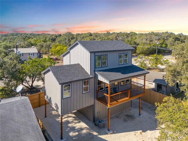 1156 Timberlane Dr, Canyon Lake, TX 78133 - rear view of property with a shingled roof and a wooded view