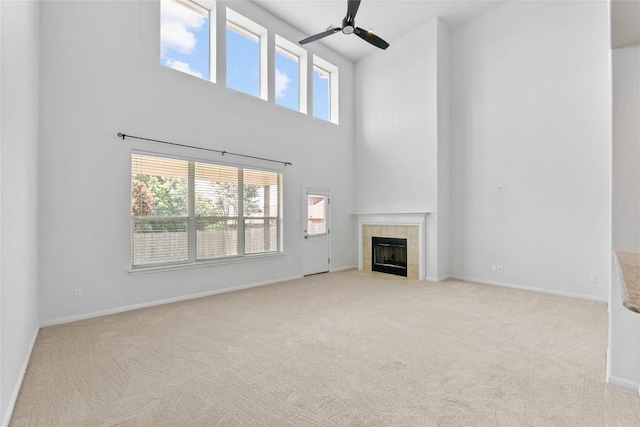 18609 Sandy Bottom Dr, Pflugerville, TX 78660 - unfurnished living room featuring a high ceiling, carpet floors, ceiling fan, and a fireplace