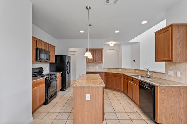 18609 Sandy Bottom Dr, Pflugerville, TX 78660 - kitchen with black appliances, tasteful backsplash, a center island, light tile patterned floors, and recessed lighting