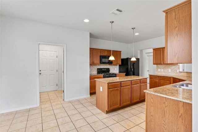 18609 Sandy Bottom Dr, Pflugerville, TX 78660 - kitchen featuring black appliances, decorative backsplash, a center island, light stone countertops, and light tile patterned flooring