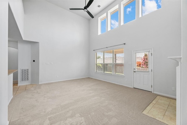 18609 Sandy Bottom Dr, Pflugerville, TX 78660 - unfurnished living room featuring a towering ceiling, carpet flooring, and a ceiling fan