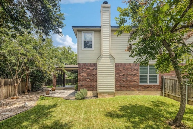 14504 Templemore Cv, Austin, TX 78717 - back of house featuring brick siding, a patio, a fenced backyard, and a chimney