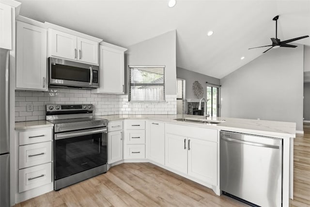 109 Campfire Cir, Copperas Cove, TX 76522 - kitchen featuring appliances with stainless steel finishes, a peninsula, vaulted ceiling, ceiling fan, and tasteful backsplash