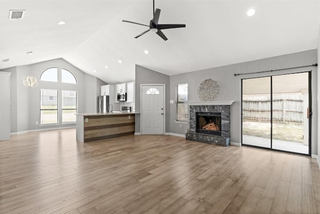 109 Campfire Cir, Copperas Cove, TX 76522 - unfurnished living room with a ceiling fan, light wood-style flooring, a stone fireplace, high vaulted ceiling, and recessed lighting