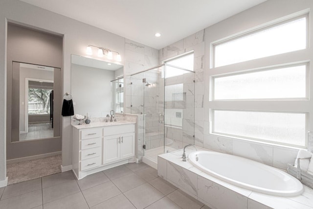 716 Dayridge Dr, Dripping Springs, TX 78620 - bathroom featuring a bath, vanity, a stall shower, tile patterned flooring, and recessed lighting