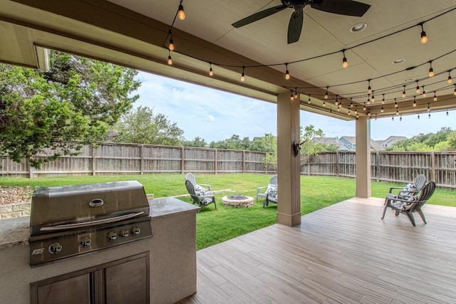 716 Dayridge Dr, Dripping Springs, TX 78620 - wooden terrace with a fenced backyard, area for grilling, ceiling fan, and an outdoor fire pit