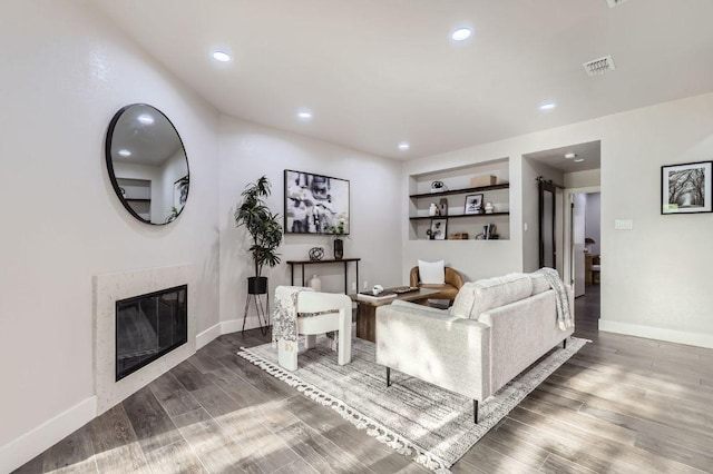 8200 Neely Dr Unit 160, Austin, TX 78759 - living area with wood finished floors, recessed lighting, built in shelves, and a premium fireplace