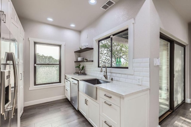 8200 Neely Dr Unit 160, Austin, TX 78759 - kitchen with stainless steel appliances, backsplash, wood finished floors, white cabinetry, and recessed lighting