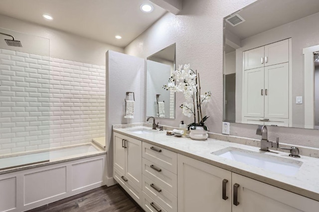 8200 Neely Dr Unit 160, Austin, TX 78759 - bathroom with double vanity, wood finished floors, a bath, a shower, and recessed lighting