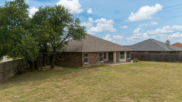 3402 Lauren St, Copperas Cove, TX 76522 - back of house featuring a fenced backyard, a patio area, brick siding, and roof with shingles