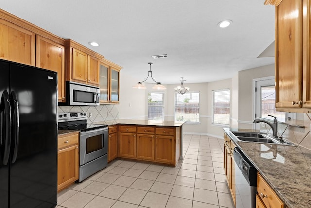 3402 Lauren St, Copperas Cove, TX 76522 - kitchen with stainless steel appliances, a peninsula, tasteful backsplash, brown cabinetry, and recessed lighting