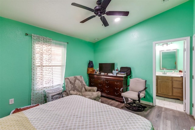 130 Los Arcos Rd, Elgin, TX 78621 - bedroom with wood finished floors, ensuite bathroom, and ceiling fan