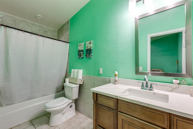 130 Los Arcos Rd, Elgin, TX 78621 - full bath featuring vanity, tile patterned floors, shower / bath combo, tile walls, and a textured wall