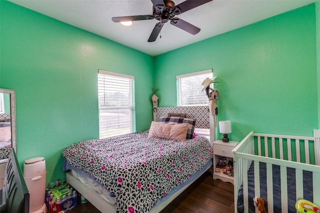 130 Los Arcos Rd, Elgin, TX 78621 - bedroom featuring wood finished floors, a textured wall, and a ceiling fan