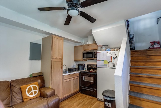 130 Los Arcos Rd, Elgin, TX 78621 - kitchen featuring electric range, stainless steel microwave, freestanding refrigerator, light wood finished floors, and ceiling fan