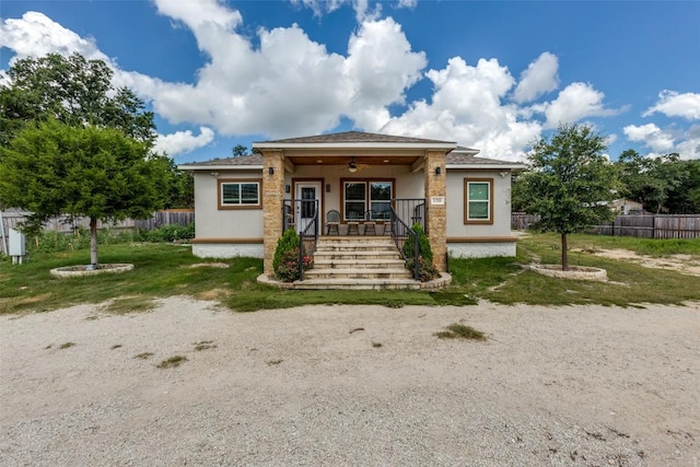130 Los Arcos Rd, Elgin, TX 78621 - view of front facade featuring ceiling fan, stucco siding, and covered porch