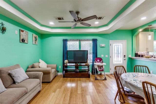 130 Los Arcos Rd, Elgin, TX 78621 - living area with a tray ceiling, light wood finished floors, a ceiling fan, and recessed lighting