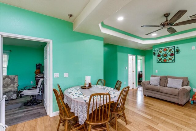 130 Los Arcos Rd, Elgin, TX 78621 - dining area featuring light wood-style flooring, a ceiling fan, a raised ceiling, and recessed lighting