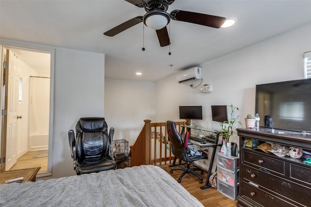 130 Los Arcos Rd, Elgin, TX 78621 - bedroom with light wood finished floors, a wall mounted AC, a desk, ensuite bathroom, and recessed lighting