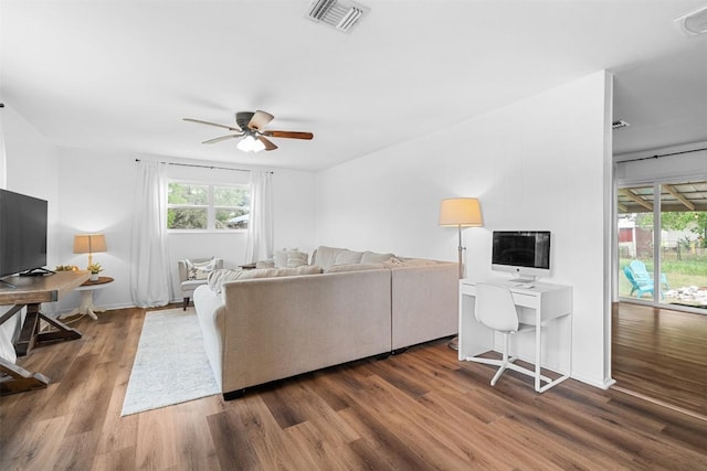 617 Johnson St, Bertram, TX 78605 - living area with wood finished floors, a desk, and ceiling fan