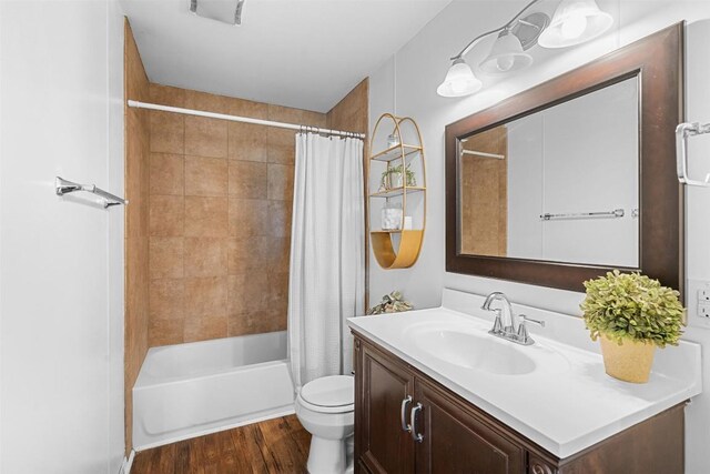 617 Johnson St, Bertram, TX 78605 - full bath with vanity, wood finished floors, and shower / bath combination with curtain