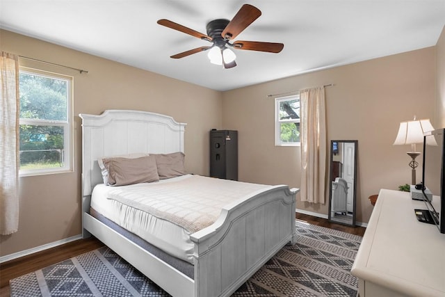 617 Johnson St, Bertram, TX 78605 - bedroom with dark wood-style floors and ceiling fan