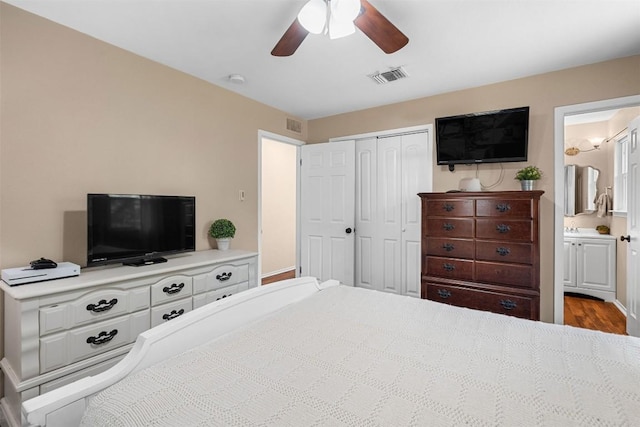 617 Johnson St, Bertram, TX 78605 - bedroom featuring a closet, a ceiling fan, wood finished floors, and ensuite bathroom