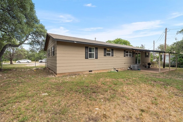 617 Johnson St, Bertram, TX 78605 - rear view of house with a patio and a lawn