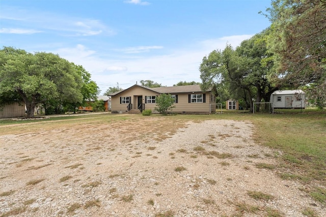 617 Johnson St, Bertram, TX 78605 - view of front of house with a storage unit