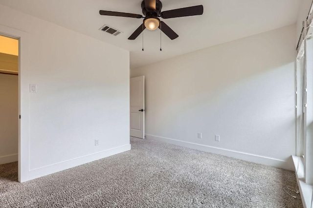 1511 Wilson Heights Dr, Austin, TX 78746 - unfurnished bedroom with carpet, a spacious closet, a ceiling fan, and a closet