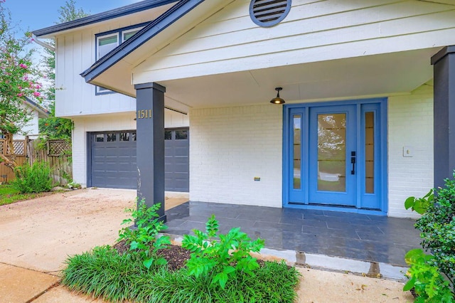 1511 Wilson Heights Dr, Austin, TX 78746 - view of exterior entry with brick siding, board and batten siding, and driveway
