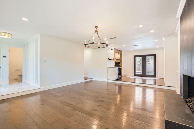 1511 Wilson Heights Dr, Austin, TX 78746 - unfurnished living room with a fireplace, hardwood / wood-style floors, a chandelier, recessed lighting, and ornamental molding