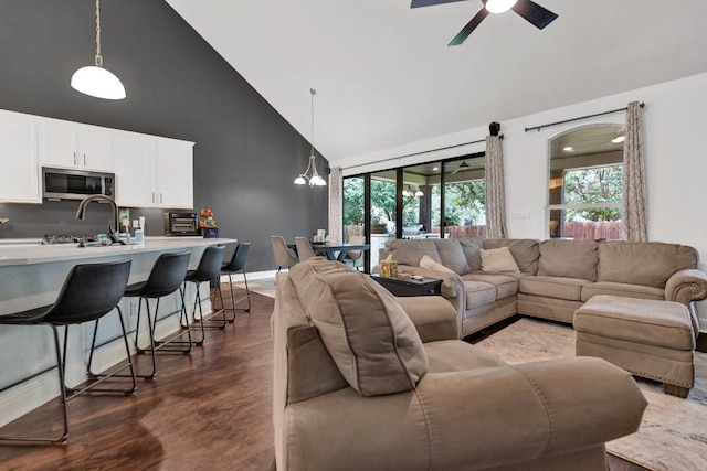 9024 Wildwater Way, Round Rock, TX 78681 - living area with high vaulted ceiling, wood finished floors, healthy amount of natural light, and a ceiling fan