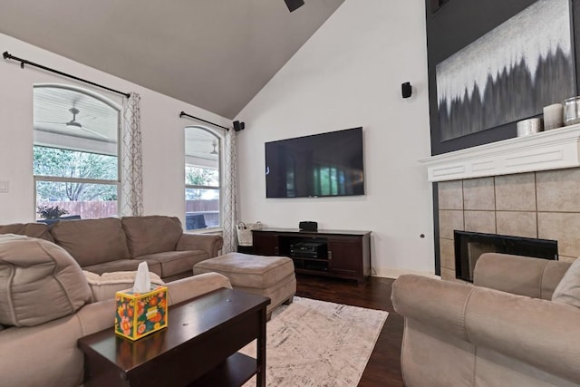 9024 Wildwater Way, Round Rock, TX 78681 - living area featuring a ceiling fan, high vaulted ceiling, dark wood-style floors, and a tile fireplace