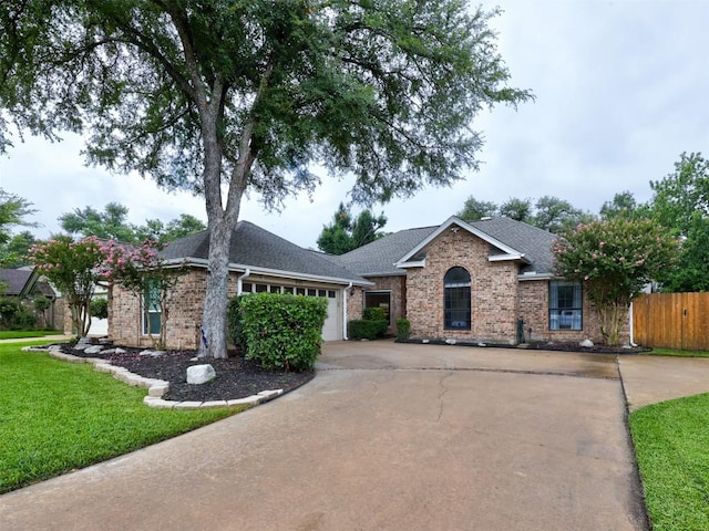 910 Blue Spring Cir, Round Rock, TX 78681 - single story home with concrete driveway, brick siding, an attached garage, and a shingled roof