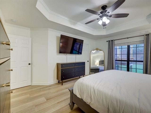 910 Blue Spring Cir, Round Rock, TX 78681 - bedroom featuring a tray ceiling, light wood-style floors, ornamental molding, and ceiling fan
