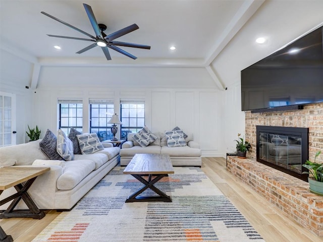 910 Blue Spring Cir, Round Rock, TX 78681 - living area featuring ceiling fan, light wood-style flooring, a fireplace, and a decorative wall