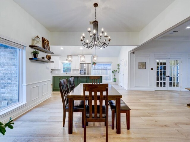 910 Blue Spring Cir, Round Rock, TX 78681 - dining area with a chandelier, light wood-style flooring, and plenty of natural light