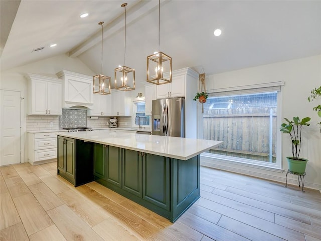 910 Blue Spring Cir, Round Rock, TX 78681 - kitchen with appliances with stainless steel finishes, white cabinetry, backsplash, a center island, and green cabinets