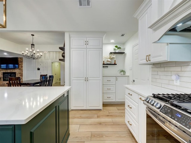910 Blue Spring Cir, Round Rock, TX 78681 - kitchen featuring stainless steel range with gas stovetop, light countertops, white cabinets, and recessed lighting