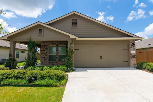 232 Reagor Dr, Taylor, TX 76574 - view of front of home featuring brick siding, driveway, and a garage