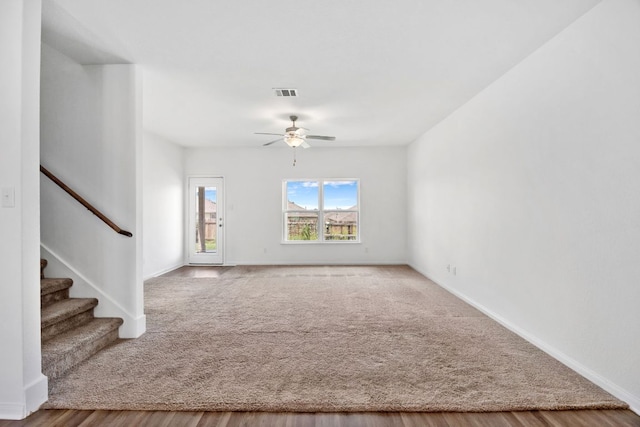 19512 Andrew Jackson St, Manor, TX 78653 - carpeted empty room featuring ceiling fan, stairs, and wood finished floors