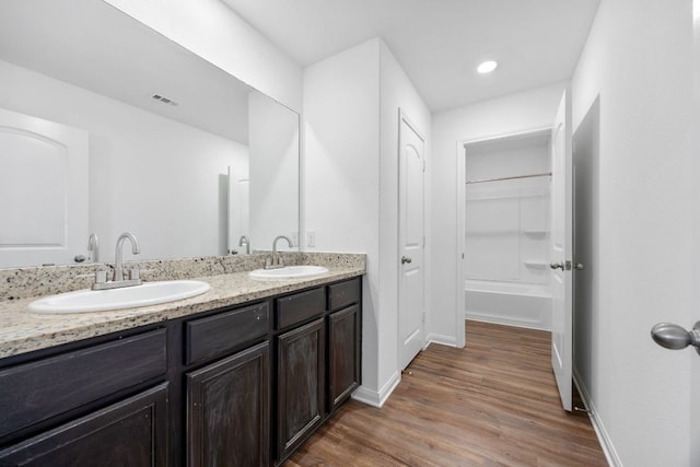 19512 Andrew Jackson St, Manor, TX 78653 - full bathroom featuring double vanity and wood finished floors