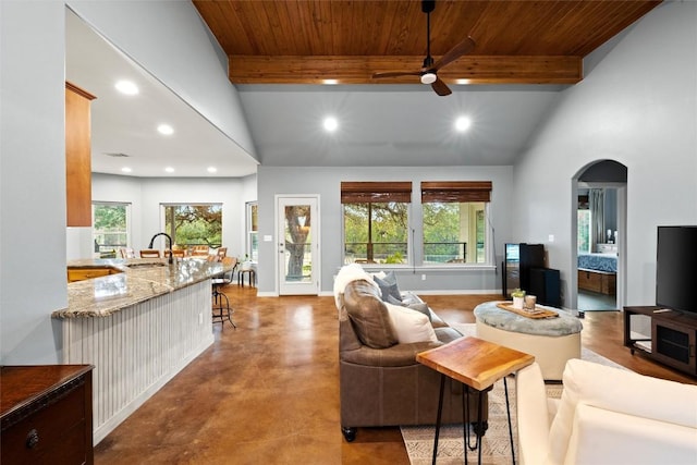 28 Long Creek Rd, Austin, TX 78737 - living room with ceiling fan, recessed lighting, plenty of natural light, arched walkways, and a wood ceiling with exposed beams