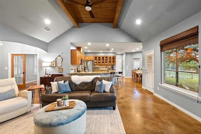 28 Long Creek Rd, Austin, TX 78737 - living room featuring finished concrete flooring, beamed ceiling, high vaulted ceiling, recessed lighting, and arched walkways
