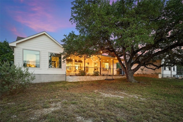 28 Long Creek Rd, Austin, TX 78737 - back of house at dusk featuring a yard